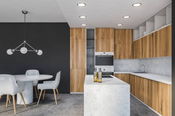 istock Grey and wood kitchen, island and table, side view 1222745600