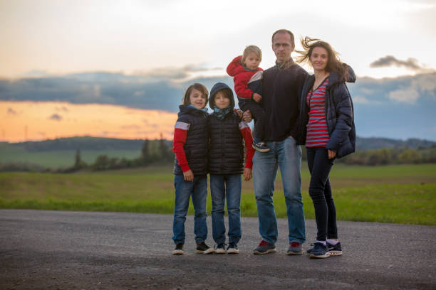 istock Beautiful family on a rural path on sunset on a very windy and cold spring evening 1222746552