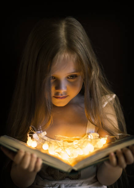 istock little girl is reading a magic book 1222748148