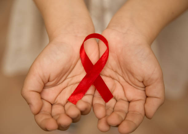 istock aids symbol in hands red ribbon 1222748190