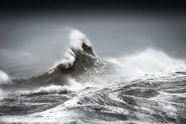 Storm 'Ciara' hits the South Coast of Britain with strong winds and huge waves Powerful Black and White Image of raging sea as powerful Winter storm 'Ciara' hits South Coast of Britain warning sign photos stock pictures, royalty-free photos & images