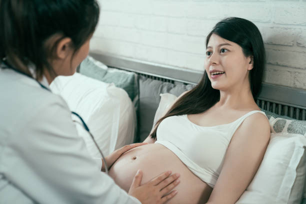 istock medical staff hands touch nake abdomen 1222751343