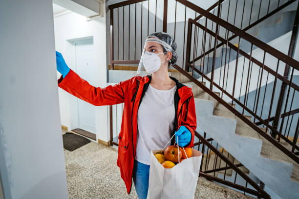 istock Woman delivering groceries during lockdown 1222753333