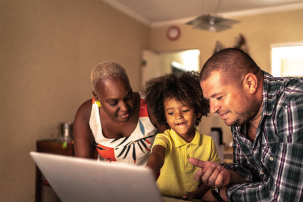 istock Parents with son using laptop at home 1222755360