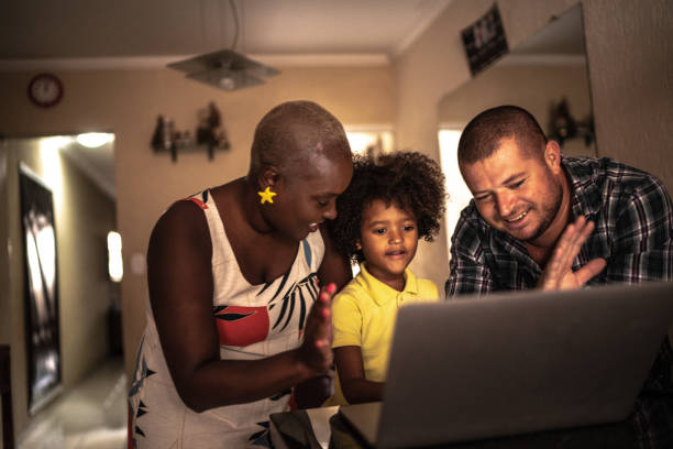 istock Parents with son doing a video conference on laptop at home 1222755526