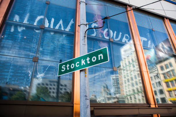 Stockton road sign San Francisco, USA Stockton road sign photographed with the city of San Francisco reflecting in the glass window. stockton california stock pictures, royalty-free photos & images