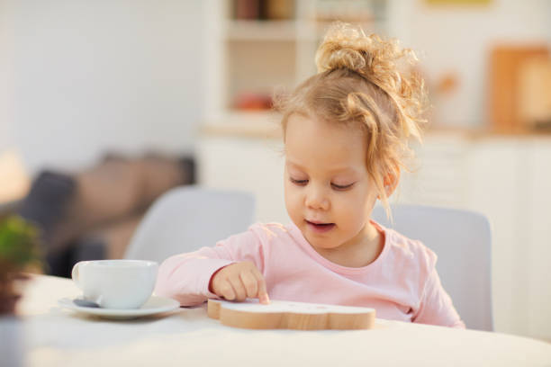 istock Little Girl Sitting At Table 1222756243