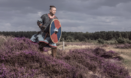 An individual viking warrior man on highland moors during a battle