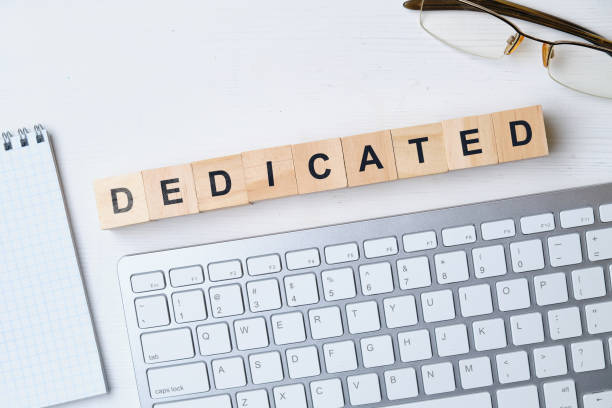 istock Modern business buzzword - dedicated. Top view on wooden table with blocks. Top view. 1222759332