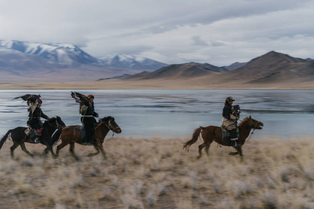 istock Eagle hunters on horses near the river in Mongolia 1222762997