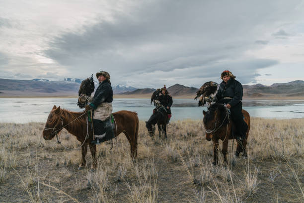istock Eagle hunters on horses near the river in Mongolia 1222763000