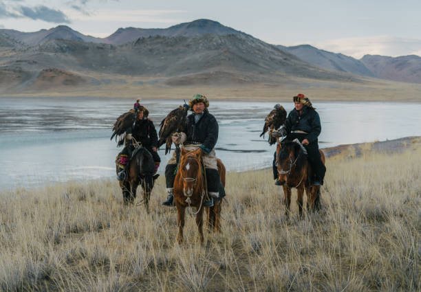 istock Eagle hunters on horses near the river in Mongolia 1222763028