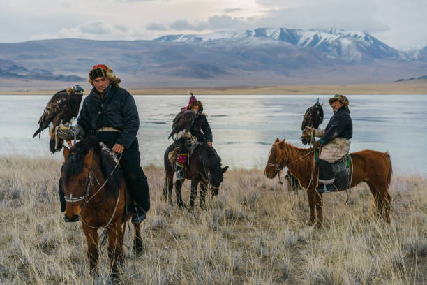 istock Eagle hunters on horses near the river in Mongolia 1222763047