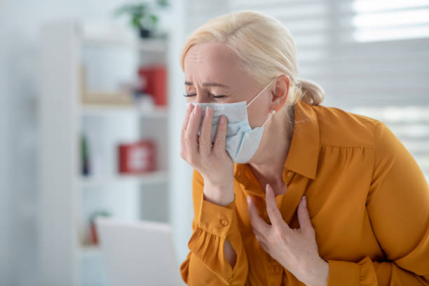 istock Fair-haired woman in a protective mask feeling ill 1222763160