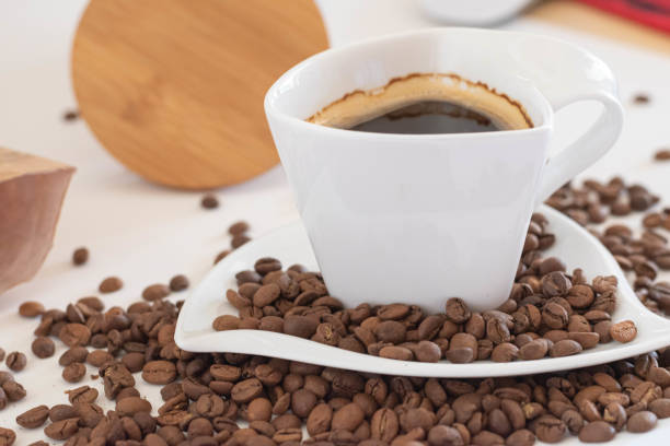 istock Coffee cup with coffee beans on white background 1222763679