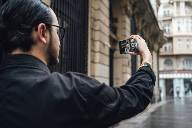 istock Handsome man taking a selfie with a mobile phone with a friend 1222764334