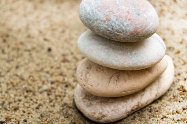 istock A stack of white stones stacked on yellow sand, low depth of field, Zen concept 1222764482