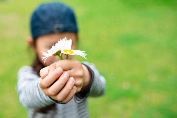 istock Child holding flowers 1222764560