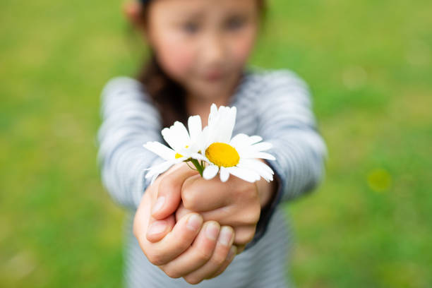 istock Child holding flowers 1222764616