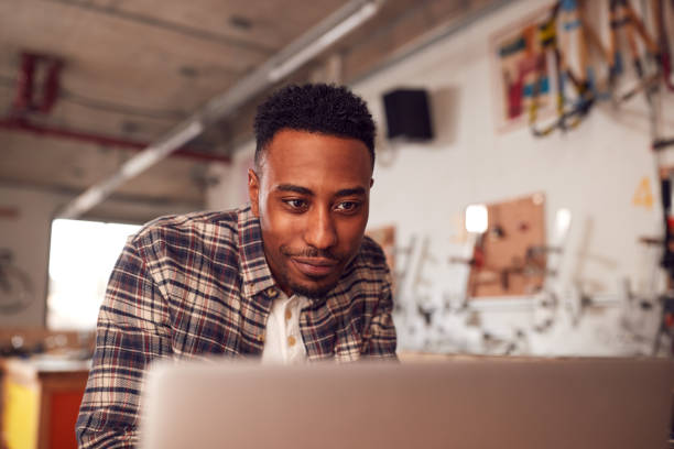 istock Male Carpenter In Workshop Doing Accounts On Laptop 1222764891