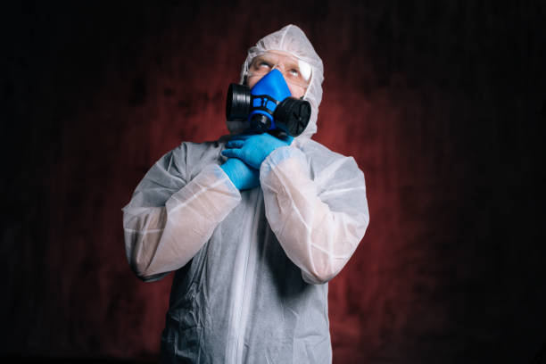 istock Scientist in hazmat, goggles and respirator strangling himself with hands. 1222764975