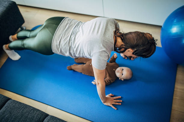 istock Mother exercising with her baby son at home 1222765928