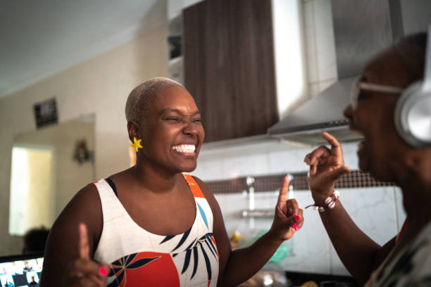 istock Mother and daughter dancing at home 1222768382