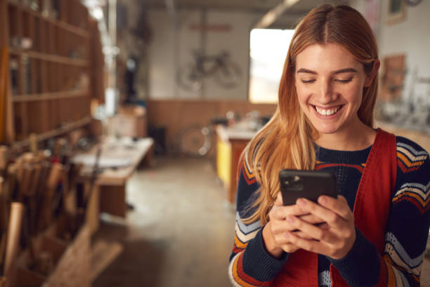 istock Female Business Owner In Workshop Using Mobile Phone 1222768423