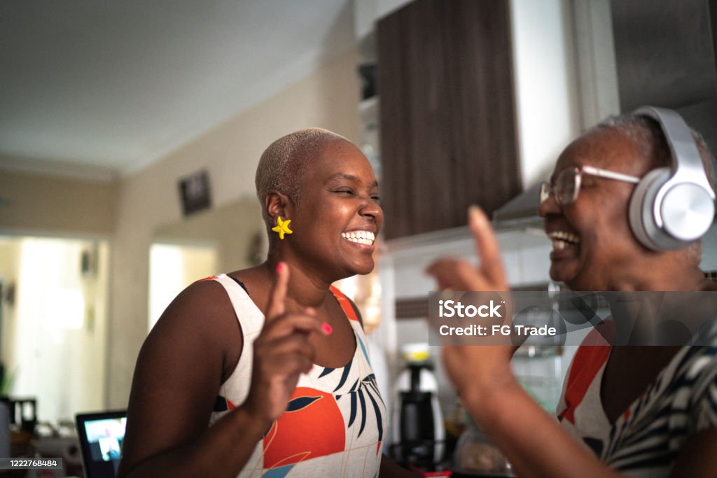 Mother and daughter dancing at home Music Stock Photo