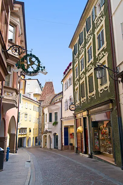 Alley in the old town of Merano (South Tyrol, Italy) with a view of the Gate Bolzano (Bozner Tor)