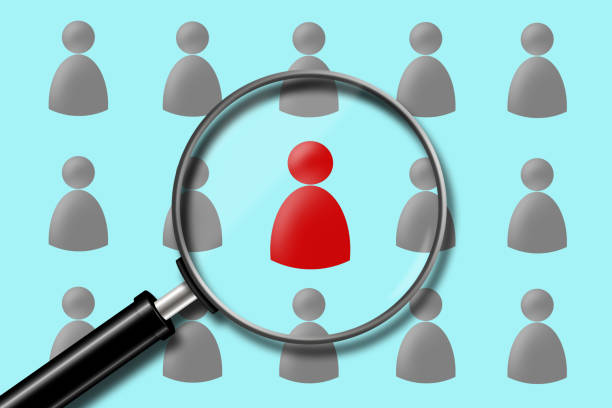 istock Search for employees. Red and gray human icons. View through a magnifying glass. Business. 1222773169