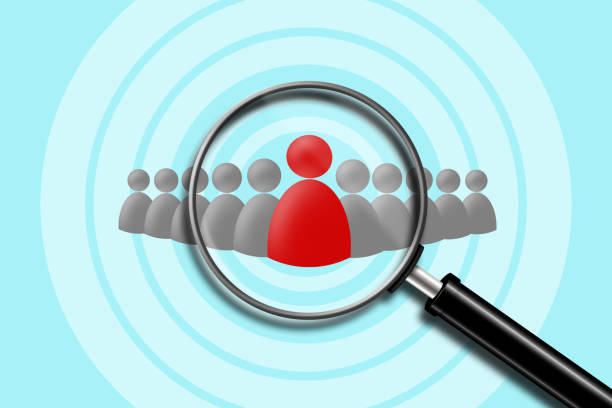 istock Search for employees. Red and gray human icons on a blue background. View through a magnifying glass. Business. 1222773174