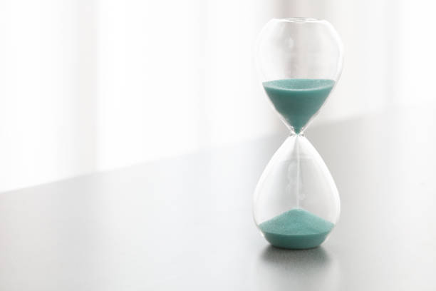 istock Closeup hourglass clock on white background. 1222773751