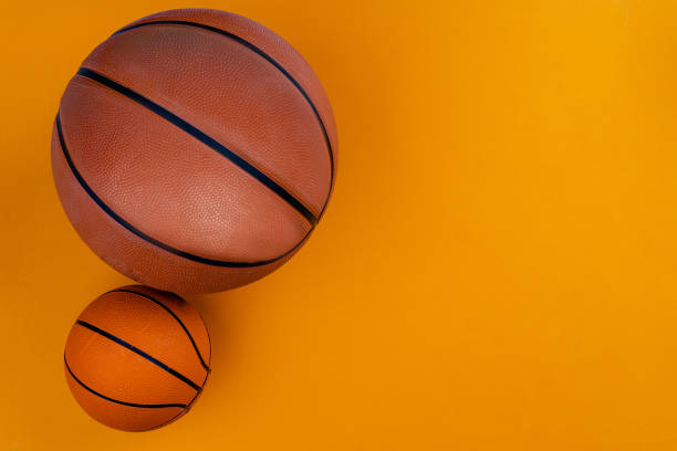 istock Ball for basket ball on an orange background 1222774039