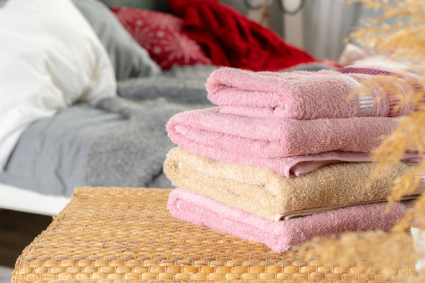 istock Stack of clean towels on wooden table in bedroom 1222774675