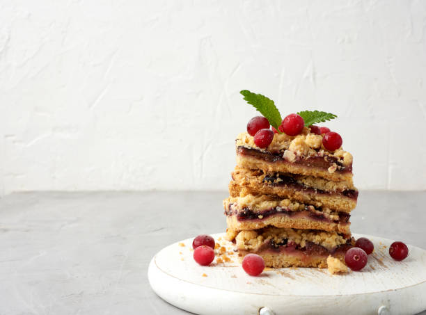 stack of square slices of baked crumble pie with blue plum