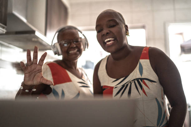 istock Mother and daughter doing a video call / vlogging on digital tablet at home 1222776943