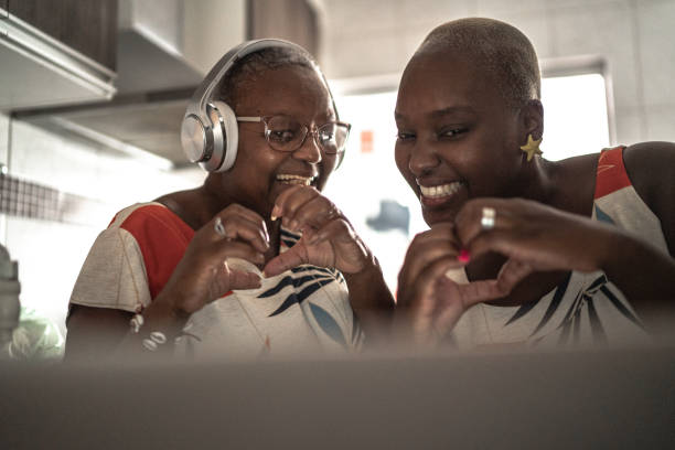 istock Mother and daughter doing a video call / vlogging on digital tablet at home 1222777038