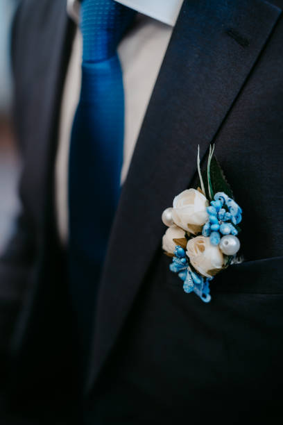 istock Artificial flower boutonniere on groom's blue jacket 1222777239