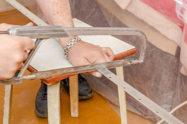 istock The use of a hacksaw blade and frame for cutting the metal construction for a stretch ceiling. 1222779953