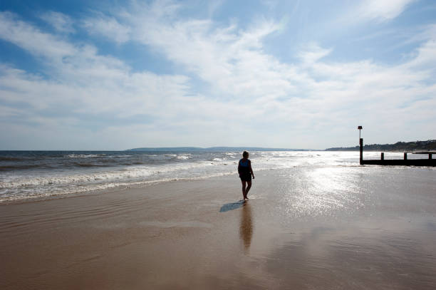 istock Single stroller on seashore beach walk on the Jurassic Coast, England, UK 1222780399