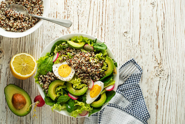 Green salad meal with quinoa, egg and avocado