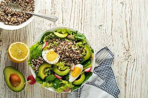Green salad meal with quinoa, egg and avocado