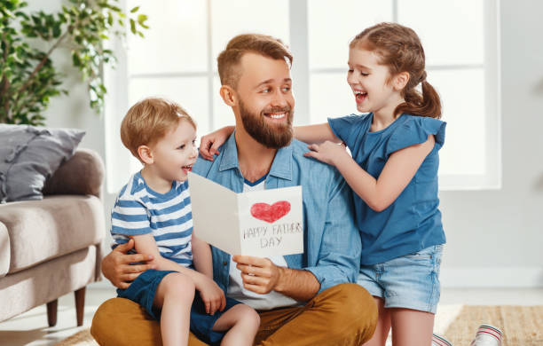 istock Happy father receiving greeting card from kids 1222780730