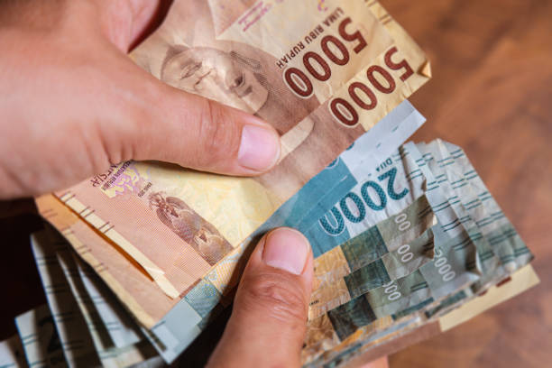 istock Indonesian Rupiah in male hand 1222781611