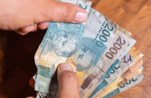 istock Indonesian Rupiah in male hand 1222781642