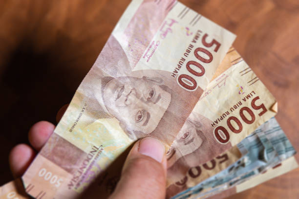 istock Indonesian Rupiah in male hand 1222781669