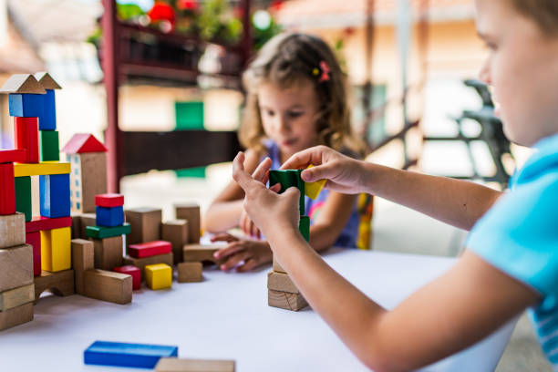 istock Happy little children playing with colorful building blocks 1222782449