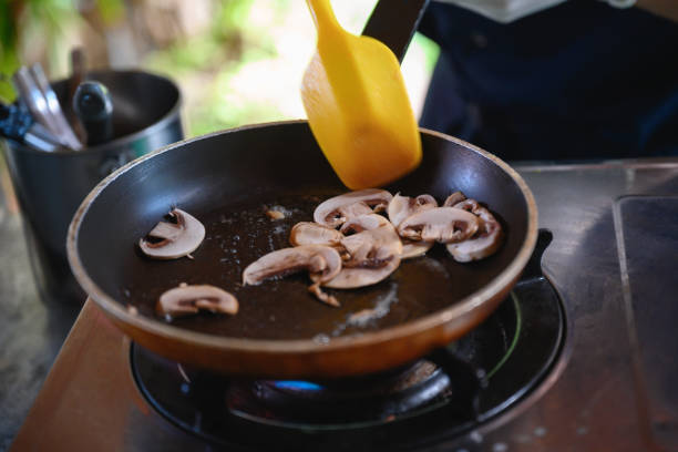 Stirring mushrooms with plastic spatula in frying pan, Nikon Z7