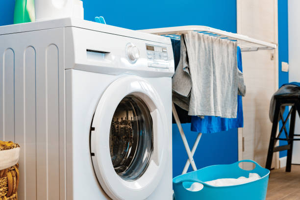istock Laundry room interior with washing machine and clothes dryer near wall 1222786472